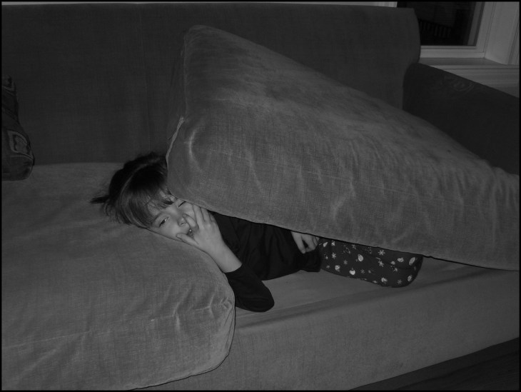 Girl under cushions BW Darker